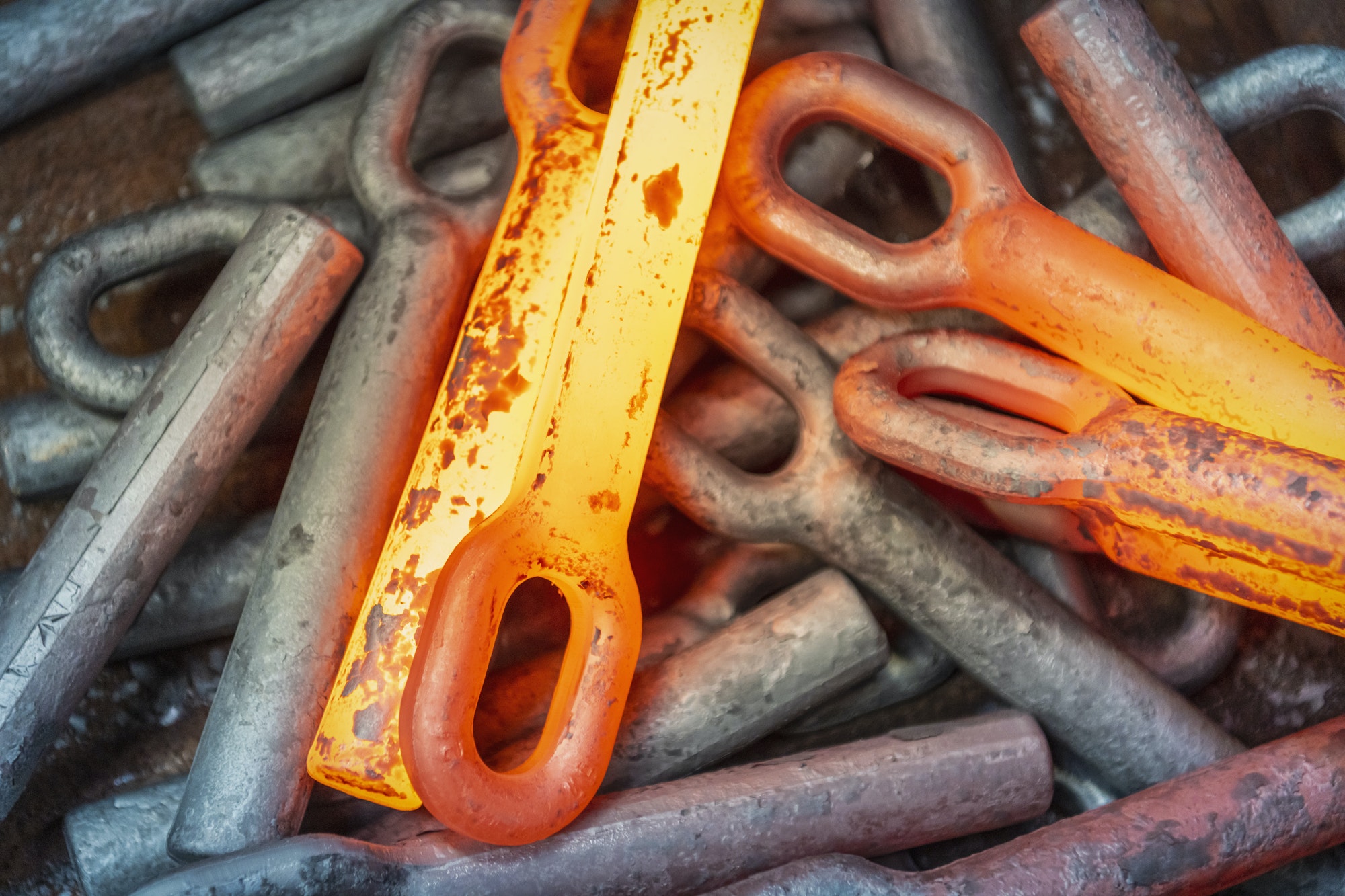 Close-up of hot forged steel parts in industrial forge